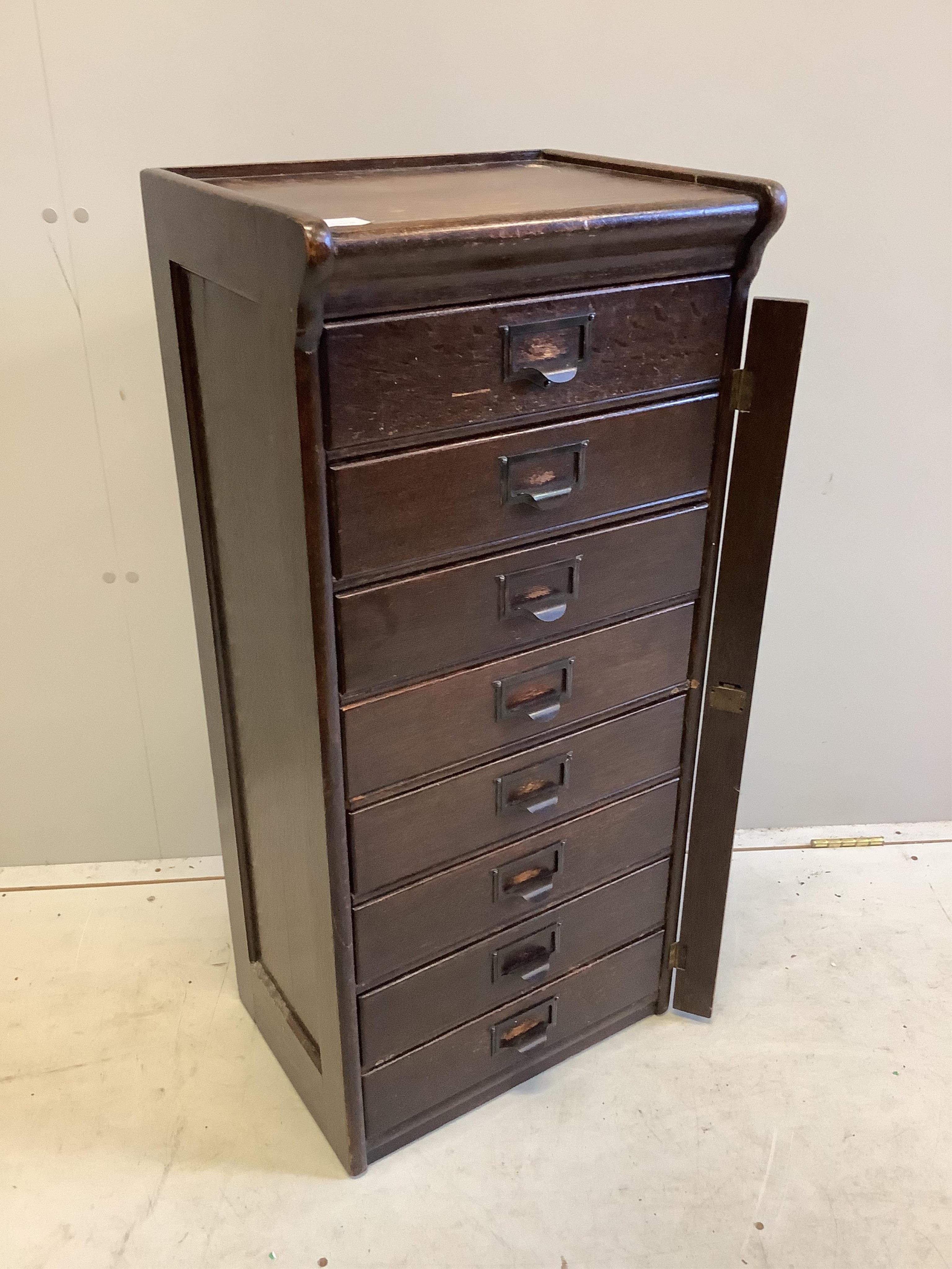 A Globe Wernicke oak eight drawer filing cabinet, width 44cm, depth 34cm, height 97cm. Condition - fair